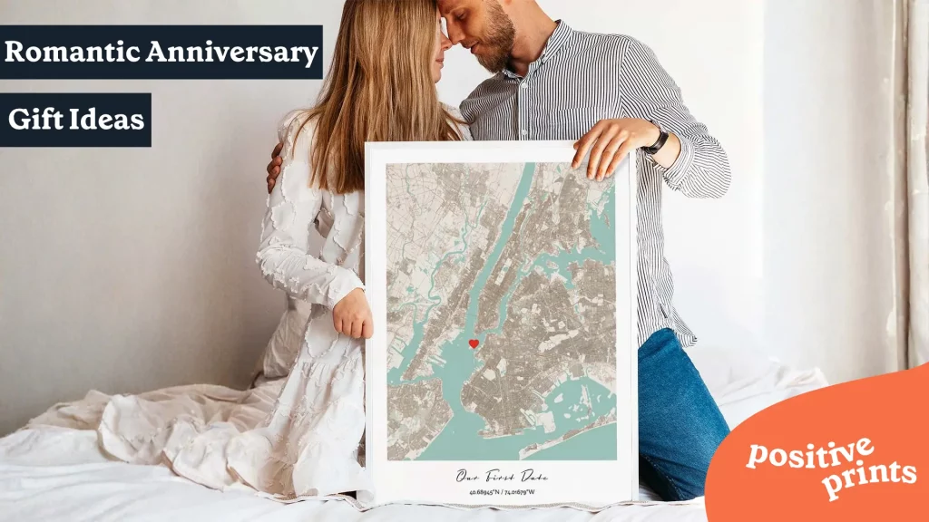 Couple sitting together with a framed custom map print marked with a heart, featured as a romantic anniversary gift idea